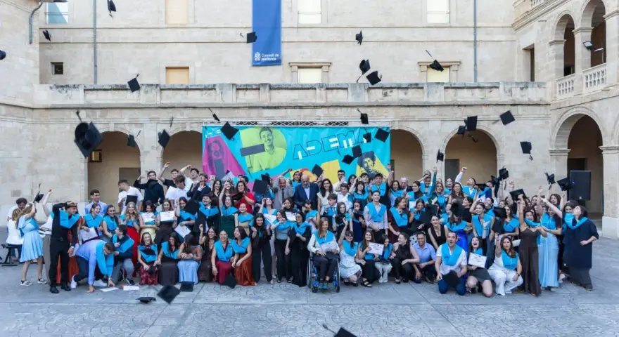 Graduados celebran lanzando birretes al aire en un evento de fp online Mallorca.