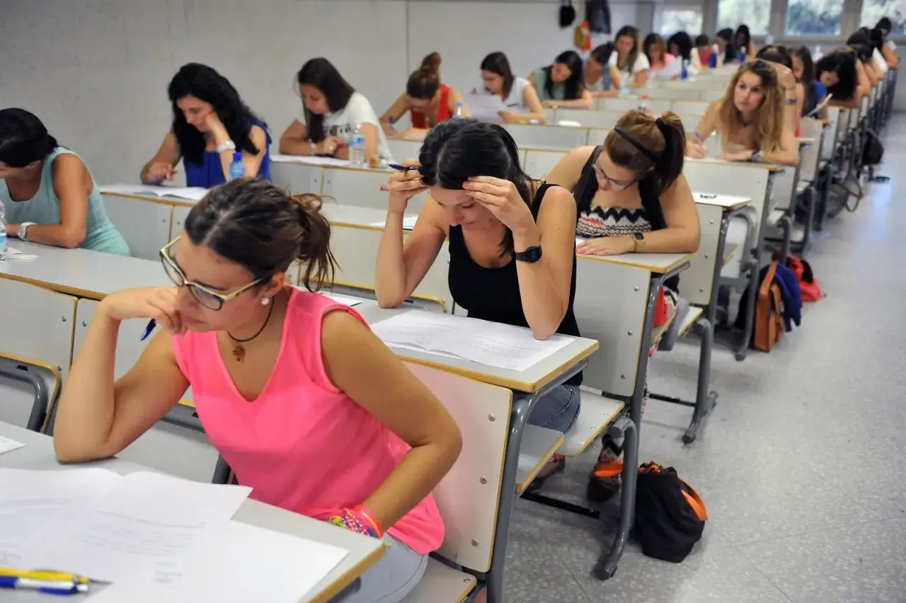 Estudiantes concentradas en un examen, prepar&aacute;ndose para sus oposiciones con grado medio.