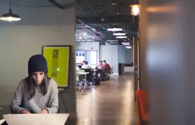Jóvenes colaboran en la formación de centros de trabajo, un espacio moderno con luz tenue y ambiente de estudio.